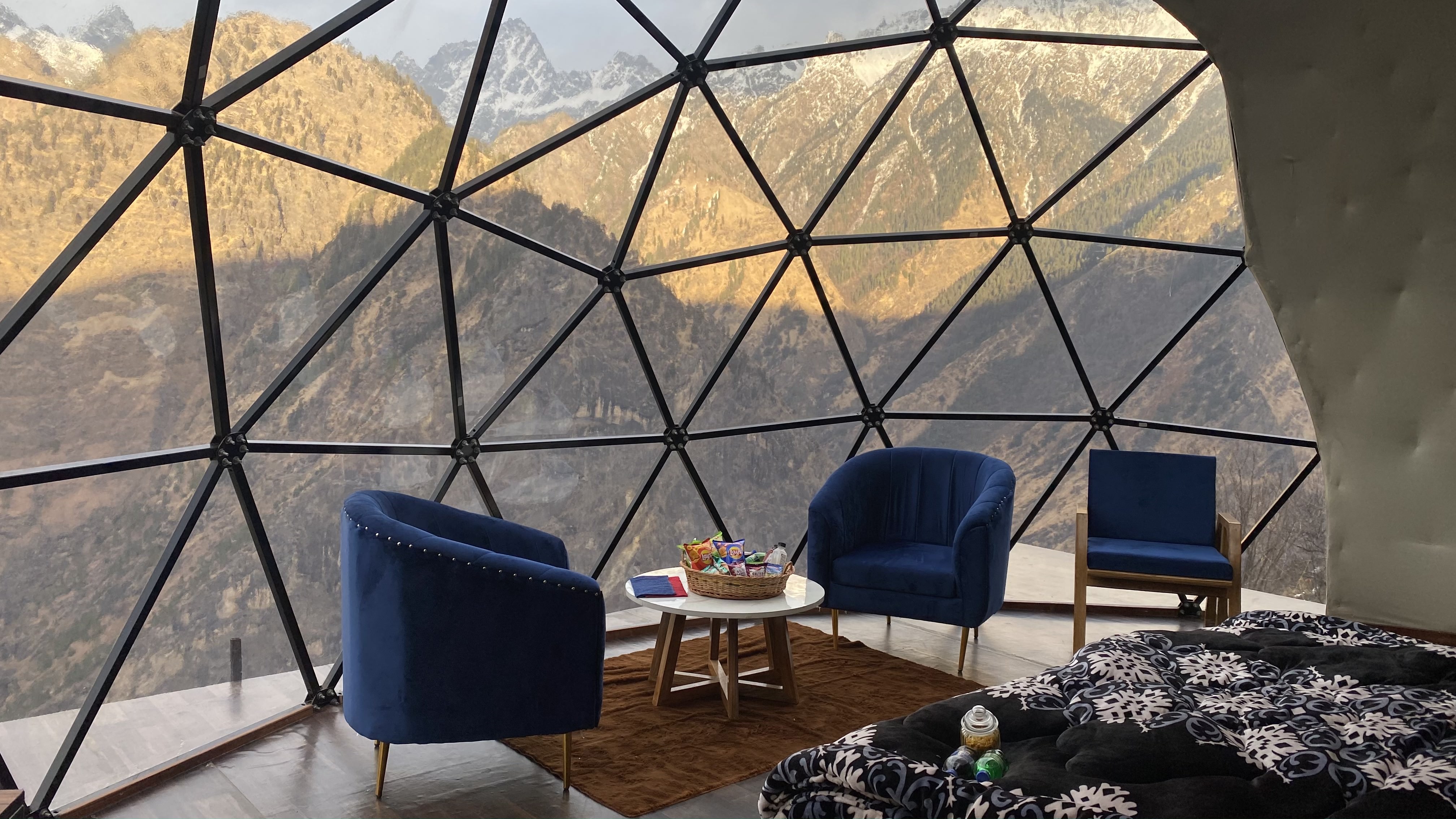 Dome House interior bedding with mountain-facing windows